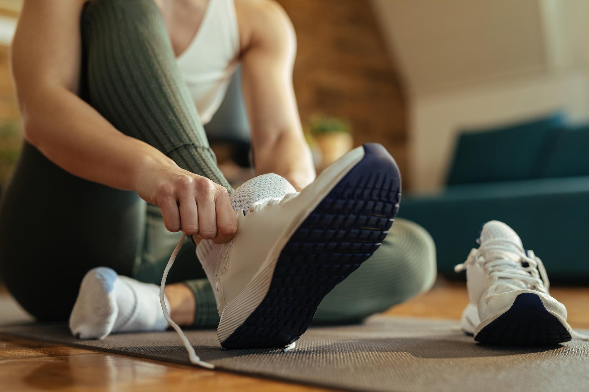 Close view of a person tying running shoes before activity